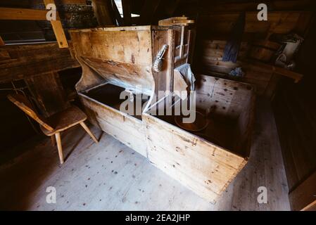 Wooden grinding gear inside the historic flour mill in the Mill Valley of Campill village, Dolomites South Tyrol, Italy Stock Photo