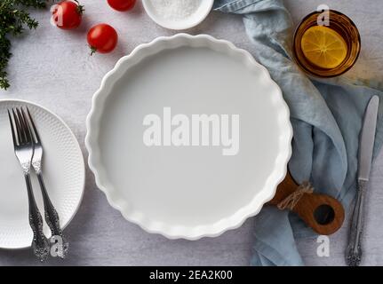 Food background mockup with round baking dish porcelain ramekin on pastel neutral grey concrete Stock Photo