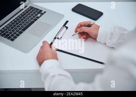 Male doctor using notebook in modern office Stock Photo