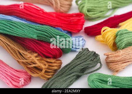 Colorful cross stitch embroidery threads. Close up. Stock Photo