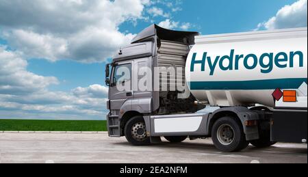 Truck on hydrogen fuel with H2 tank trailer on a background of green field and blue sky Stock Photo