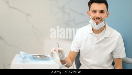 Portrait of a young smiling dentist at the dental office Stock Photo