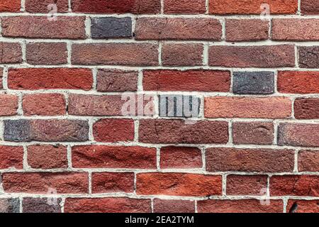 Very original solid stable brick wall as a background or texture. Unique masonry and color Stock Photo