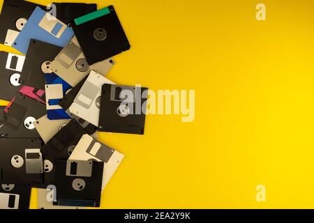 Floppy disk 3.5 inch. The diskettes 3 2 are a technology icons of de decade of 80s. Retro, vintage and colourful computer diskette. Yellow background. Stock Photo