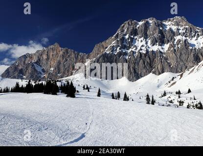 Ski Area Ehrwalder Alm With View To Mount Zugpitze Austria On A Beautiful Sunny Winter Day With  a Clear Blue Sky Stock Photo