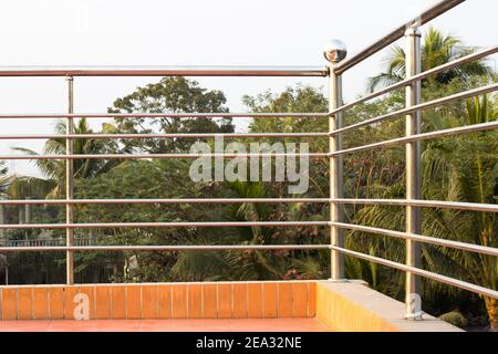 Metal railing on the rooftop of a house with nature view Stock Photo