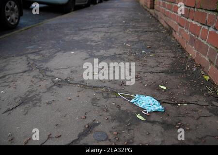 Cardiff, Wales - February 3rd 2021: A discarded face mask left on the street Stock Photo