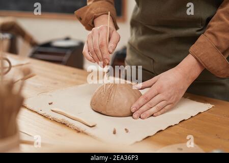 Warm toned close up of young woman making ceramic bowl in pottery workshop, small business concept, copy space Stock Photo