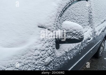 Windscreen / wind shield / frontscreen / windshield of parked car covered in snow during cold weather in winter Stock Photo