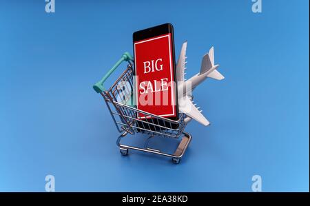 Shopping cart with plane toy. Air tickets sale concept. Stock Photo