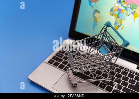 Empty shopping cart on laptop. Online shopping concept. Stock Photo