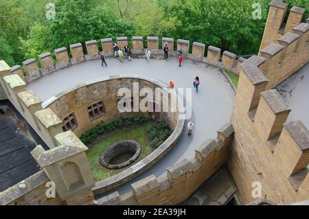 Bisingen, Germany - May 2009: Visitors at one of the central courtyards at Burg Hohenzollern. This castle is located on the mountain Hohenzollern Stock Photo