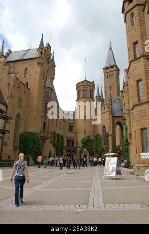 Bisingen, Germany - May 2009: Visitors at one of the central courtyards at Burg Hohenzollern. This castle is located on the mountain Hohenzollern Stock Photo