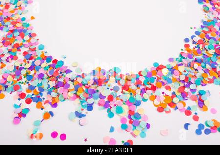 colorful confetti on a white background. Top view. Stock Photo