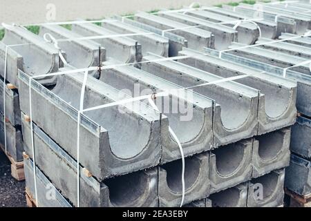 Construction cement blocks for road construction gutter and sewer on a city street Stock Photo