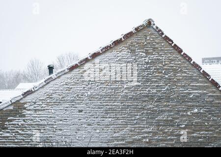 Beautiful textured effect on the wall of a house, caused by blowing snow during a blizzard Stock Photo