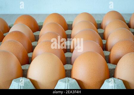 Fresh eggs in a carton tray Stock Photo