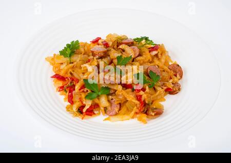 Stewed vegetables, cabbage, paprika with sausages. Studio Photo Stock Photo