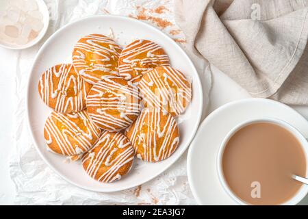 Sweet cookies with lemon filling and white chocolate on a soft light background. Stock Photo
