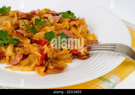 Stewed vegetables, cabbage, paprika with sausages. Studio Photo Stock Photo