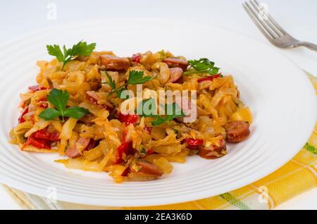 Stewed vegetables, cabbage, paprika with sausages. Studio Photo Stock Photo