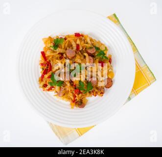 Stewed vegetables, cabbage, paprika with sausages. Studio Photo Stock Photo