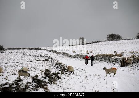 Winter bike ride over Longstone Edge in the Derbyshire Peak District National Park Stock Photo