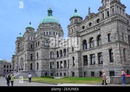 Victoria, BC, Canada -  Visitors walk past the front of the baroque style provincial parliament building of British Columbia, in the ca Stock Photo