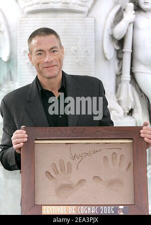 Belgian actor and producer Jean-Claude Van damme poses with his handprints in clay during the 23rd Cognac Detective Film Festival in Cognac, France, on April 9, 2005. Photo by Patrick Bernard/ABACA. Stock Photo