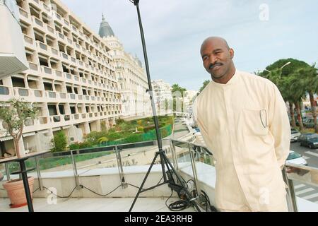 Legendary American boxer 'four times Heavyweight World Champion' Evander Holyfield poses at the Hilton Hotel during the MIPTV 2005 in Cannes, France on April 13, 2005 to promote his autobiographic documentary TV, 'The Real Deal'. Photo by Gerald Holubowicz/ABACA. Stock Photo