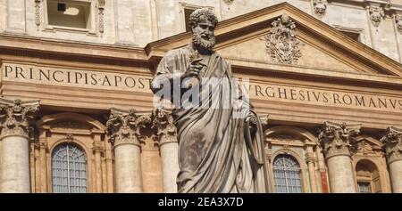 Sculpture with St. Peters square and Saint Peter basilica in Rome in Italy with blue sky Stock Photo