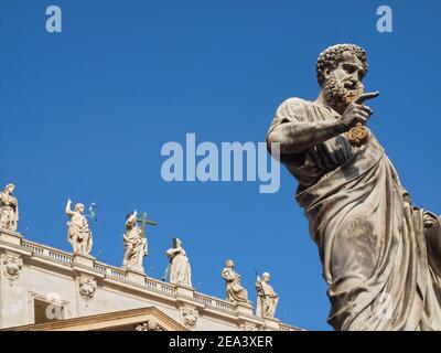 Sculpture with St. Peters square and Saint Peter basilica in Rome in Italy with blue sky Stock Photo