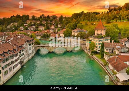 Dramatic stormy sky with sunset colors over Aare river. Skyline of Bern, capital of Switzerland and cityscape view of old city and Untertorbrucke Stock Photo