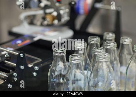 Close up background image of bottles at conveyor belt at food factory, copy space Stock Photo