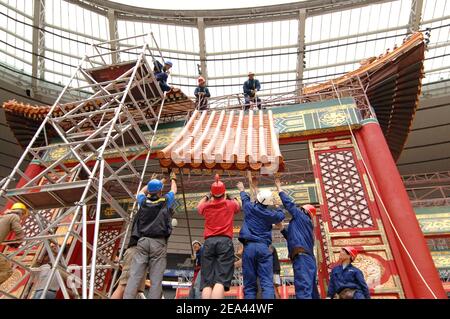 EXCLUSIVE. Chinese workers start building a 150m stage set to recreate Beijing's Forbidden City inside the Stade de France stadium, near Paris, France, on May 16, 2005, for a spectacular production of Puccini's Opera 'Turandot' by Chinese director Zhang Yimou, to be staged live on May 28, with 450 performers of the China National Dance Ensemble wearing 1,000 embroidered silk costumes. Photos by Stephane Kempinaire-Nicolas Gouhier/CAMELEON/ABACA. Stock Photo