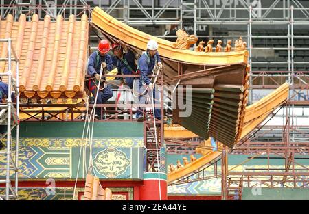 EXCLUSIVE. Chinese workers start building a 150m stage set to recreate Beijing's Forbidden City inside the Stade de France stadium, near Paris, France, on May 16, 2005, for a spectacular production of Puccini's Opera 'Turandot' by Chinese director Zhang Yimou, to be staged live on May 28, with 450 performers of the China National Dance Ensemble wearing 1,000 embroidered silk costumes. Photos by Stephane Kempinaire-Nicolas Gouhier/CAMELEON/ABACA. Stock Photo