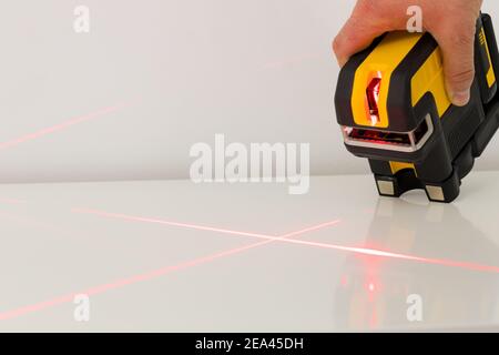 Electronic laser pointing straight lines. Checking angles and setting points while taking measurements Stock Photo