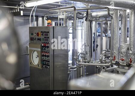 Background image of industrial workshop at production plant, control panel with buttons and displays in foreground, copy space Stock Photo