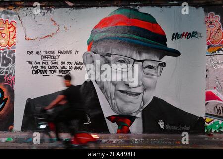 London (UK): Mural of Captain Sir Tom Moore on a wall in central London.Moore raised over 30 million pounds for covid research. Stock Photo
