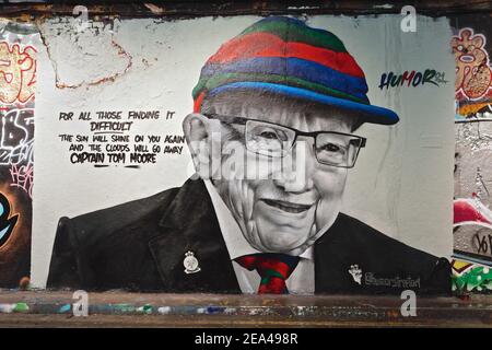 London (UK): Mural of Captain Sir Tom Moore on a wall in central London.Moore raised over 30 million pounds for covid research. Stock Photo
