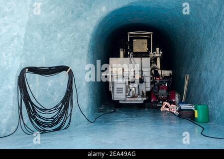 Ice tunnel and cave maintenance equipment parked in dedicated ice garage at bottom of Mer the Glace glacier in Chamonix France Stock Photo