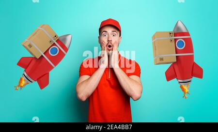 Courier has a wondered expression about a great promotion. Concept of fast delivery like a rocket. cyan background Stock Photo