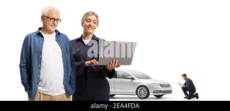 Mature male customer and a female auto mechanic looking at a laptop computer isolated on white background Stock Photo
