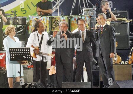 Culture Minister and music legend Gilberto Gil on stage, Brazilian President wife Marissa with Luiz Ignacio Lula da Silva and Paris Mayor Bertrand Delanoe, at the Place de la Bastille in Paris on July 13, 2005. Lula is in France on a four-day official visit and to attend the Bastille Day ceremonies during which Brazil is the guest country. Photo By Giancarlo Gorassini/Abacapress.COM Stock Photo