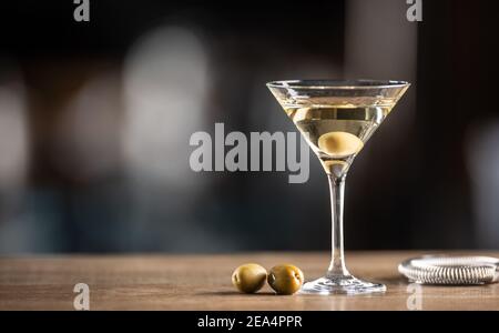 Dry Martini short drink cocktail with gin, dry vermouth and an olive garnish. Stock Photo