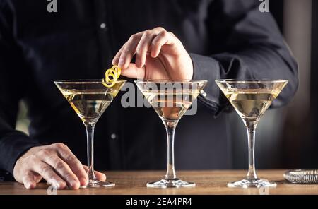 Dry Martini short drink cocktail with gin, dry vermouth and a lemon zest garnish. Stock Photo