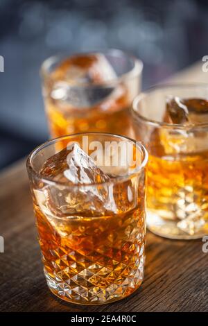 Whiskey bourbon on ice served in decorative glasses. Stock Photo