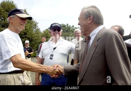 Secretary of Defense Donald H. Rumsfeld (R) meets with actor Clint Eastwood in Arlington, Va., USA, on August 8, 2005 on the set during filming of the World War II epic movie 'Flags of Our Fathers,' which centers on the Battle of Iwo Jima. The 1945 battle will forever be remembered not only due to the fact it was a turning point in World War II, but because of the lasting image of U.S. servicemen raising the American flag on Mount Suribachi. Photo by US Air Force Tech. Sgt. Kevin J. Gruenwald/DoD via ABACAPRESS.COM. Stock Photo