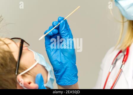 Pediatrician or doctor taking nasal mucus test, covid - 19 test . covid virus testing procedure concept Stock Photo