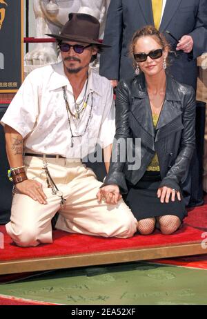 Johnny Depp and his longtime partner, Vanessa Paradis, have split. A publicist for Depp said in a statement Tuesday June 19, 2012, that the two 'have amicably separated.' The statement requested privacy for the former couple and their two children, 9-year-old son, Jack, and 13-year-old daughter, Lily-Rose. File photo : Actor Johnny Depp and his wife French actress Vanessa Paradis look at a billboard featuring Depp at the Grauman's Chinese Theatre in Hollywood September 16, 2005. Depp took part in ceremony leaving his signature, handprints and footprints in cement at the theatre. Photo by Lione Stock Photo